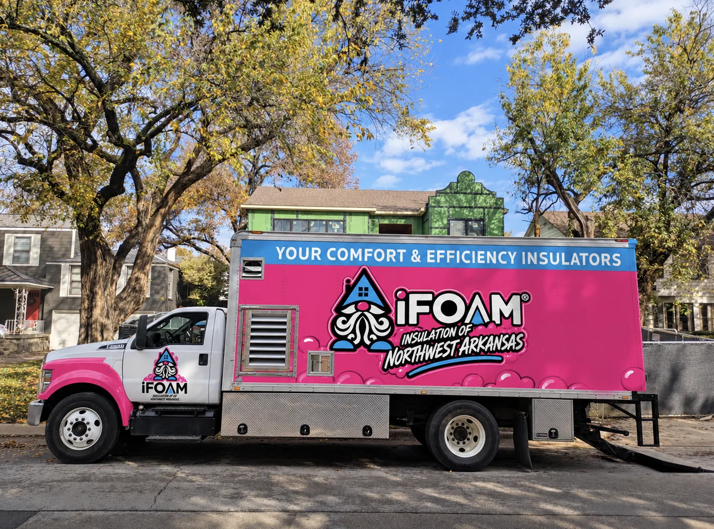 The branded iFOAM of Northwest Arkansas box truck on a residential street
